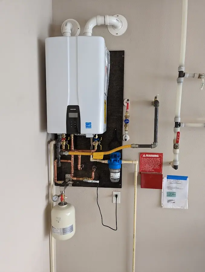 Professional plumber installing copper piping in a Monticello home